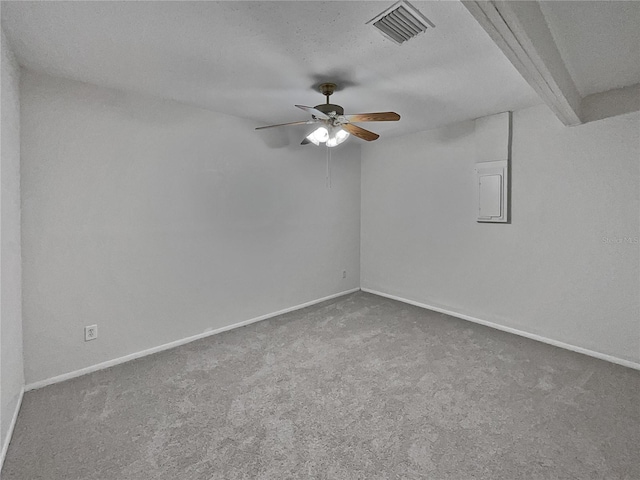 carpeted spare room with beam ceiling, electric panel, ceiling fan, and a textured ceiling