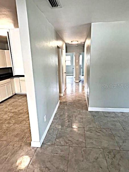 corridor featuring tile patterned floors