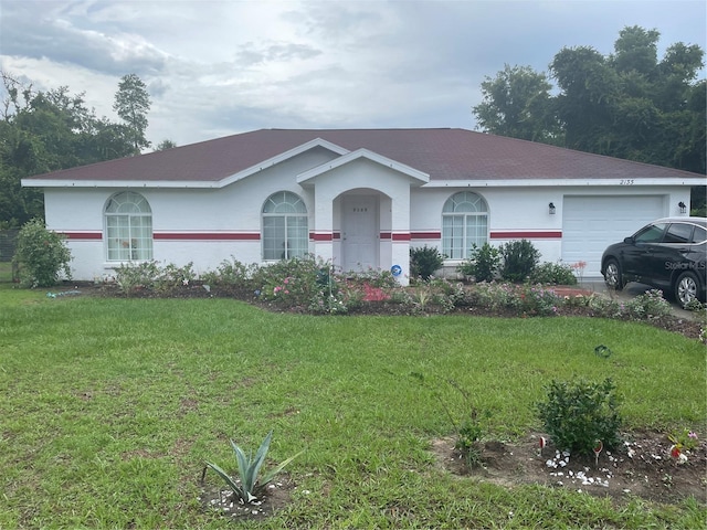 ranch-style house featuring a garage and a front lawn