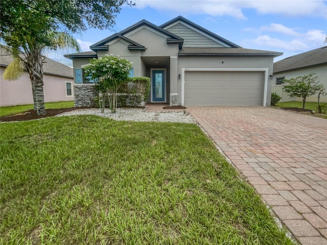 view of front of home with a garage and a front yard