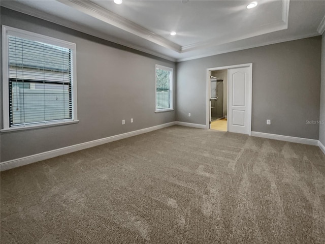 unfurnished bedroom featuring crown molding, carpet floors, connected bathroom, and a raised ceiling