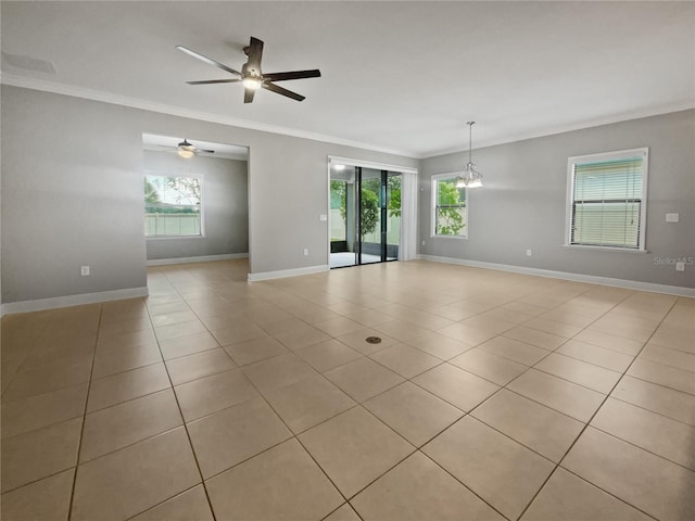 spare room featuring light tile patterned flooring, plenty of natural light, ceiling fan with notable chandelier, and ornamental molding