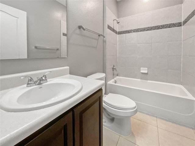 full bathroom featuring toilet, vanity, tiled shower / bath combo, and tile patterned flooring