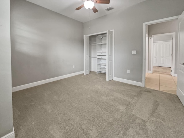 unfurnished bedroom featuring ceiling fan, a closet, and carpet flooring