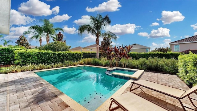 view of swimming pool featuring an in ground hot tub