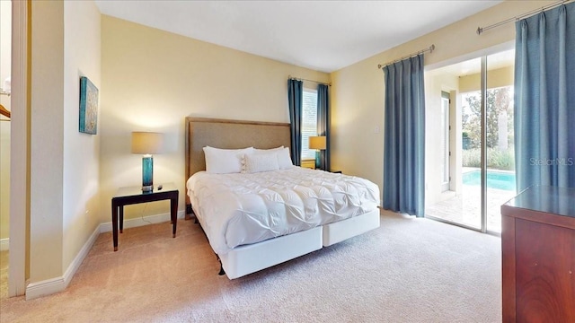 bedroom featuring access to exterior, carpet floors, and multiple windows