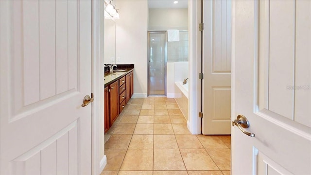 bathroom with separate shower and tub, vanity, and tile patterned floors