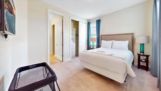 bedroom with a closet and light carpet