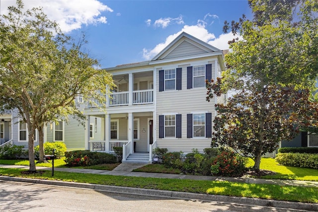 neoclassical / greek revival house with a balcony and covered porch