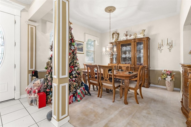 tiled dining area with crown molding and decorative columns