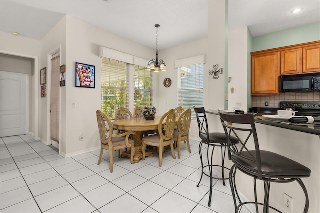 dining space featuring a chandelier and light tile patterned floors