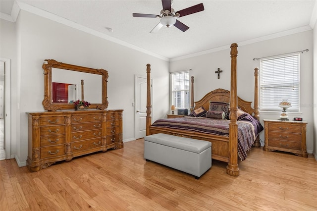 bedroom with ceiling fan, ornamental molding, light hardwood / wood-style floors, and a textured ceiling