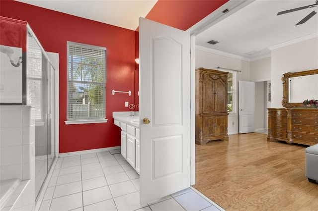 bathroom featuring wood-type flooring, vanity, ornamental molding, ceiling fan, and walk in shower