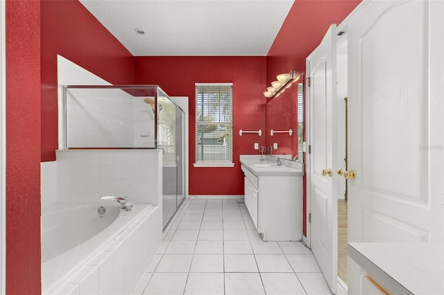 bathroom with vanity, tile patterned flooring, and shower with separate bathtub