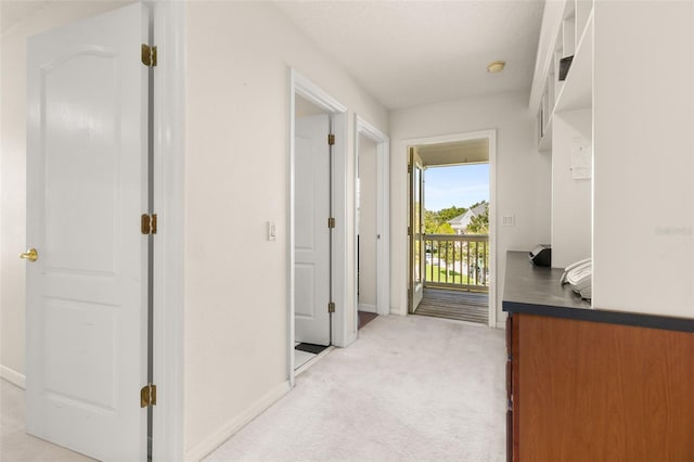 hall featuring light colored carpet