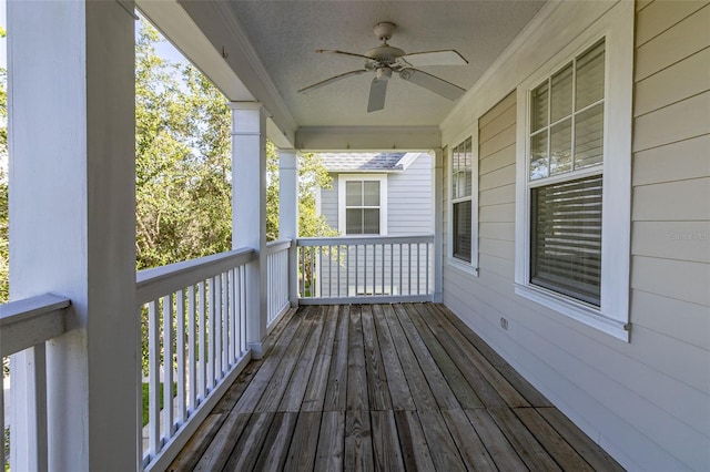 wooden terrace featuring ceiling fan