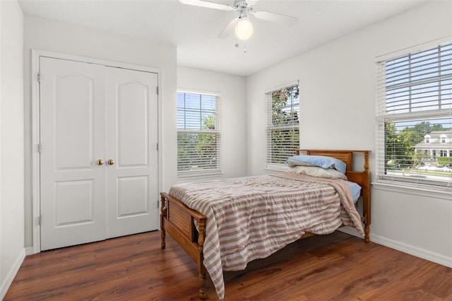 bedroom with ceiling fan, dark hardwood / wood-style flooring, and a closet