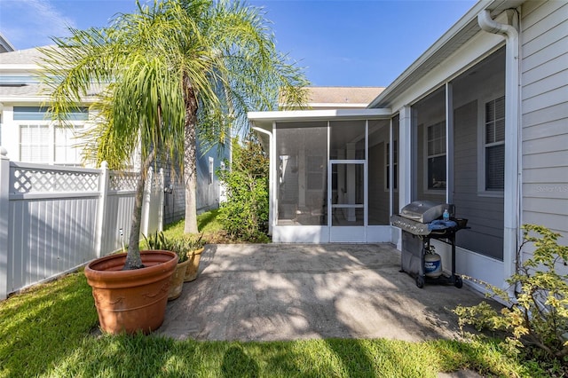 view of patio / terrace featuring a sunroom and area for grilling