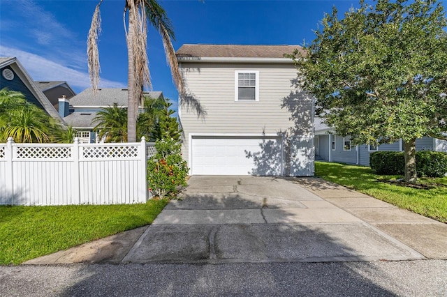 view of front of property featuring a garage and a front yard