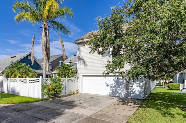 view of side of property featuring a garage and a lawn