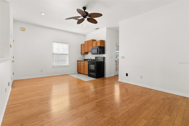 unfurnished living room featuring ceiling fan and light hardwood / wood-style flooring