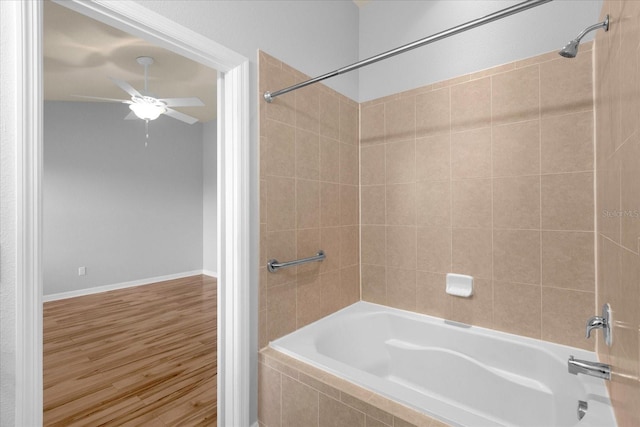 bathroom with tiled shower / bath, wood-type flooring, and ceiling fan