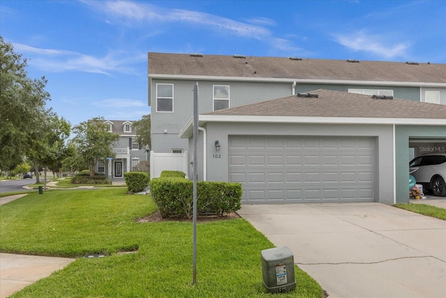 view of front of house with a garage and a front lawn