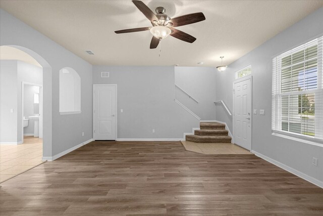 entryway featuring dark wood-type flooring, ceiling fan, and a wealth of natural light