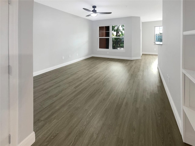 empty room featuring dark wood-type flooring and ceiling fan