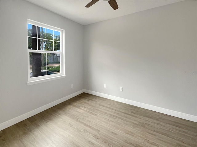 empty room featuring light wood-type flooring and ceiling fan