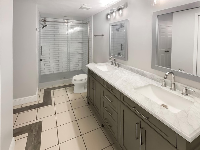 bathroom featuring tile patterned floors, toilet, vanity, and tiled shower