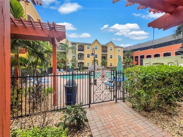 exterior space featuring a community pool and a pergola