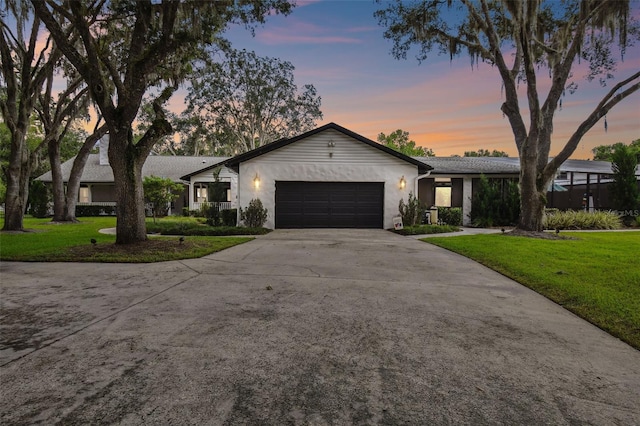 ranch-style house with a lawn and a garage