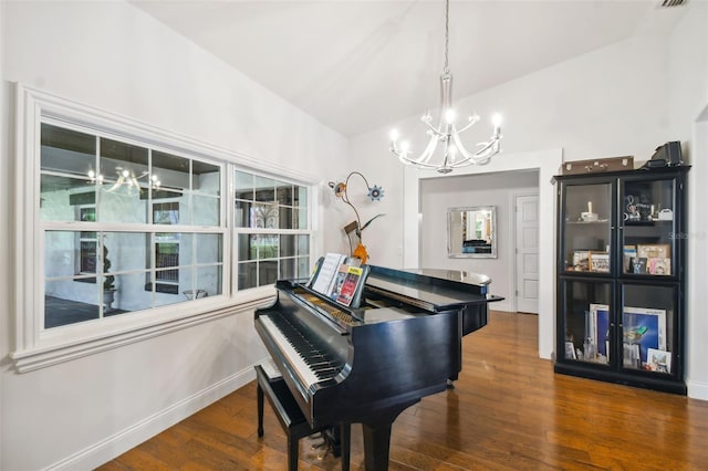 miscellaneous room with dark wood-type flooring, lofted ceiling, and a notable chandelier