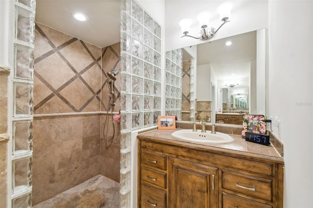 bathroom with vanity and a tile shower