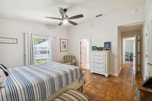 tiled bedroom featuring ceiling fan