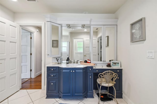 bathroom featuring tile patterned flooring and vanity