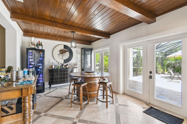 dining room with wooden ceiling, wine cooler, and french doors