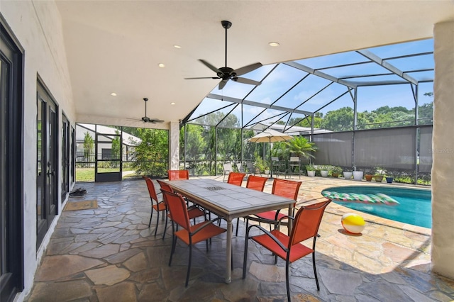 view of patio / terrace with ceiling fan, a fenced in pool, and a lanai