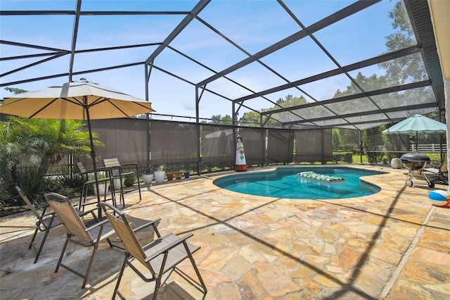 view of pool featuring glass enclosure and a patio