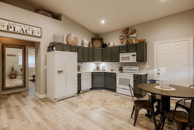 kitchen with white appliances, light hardwood / wood-style flooring, and lofted ceiling