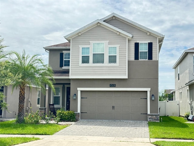 view of front of home featuring a garage and a front yard