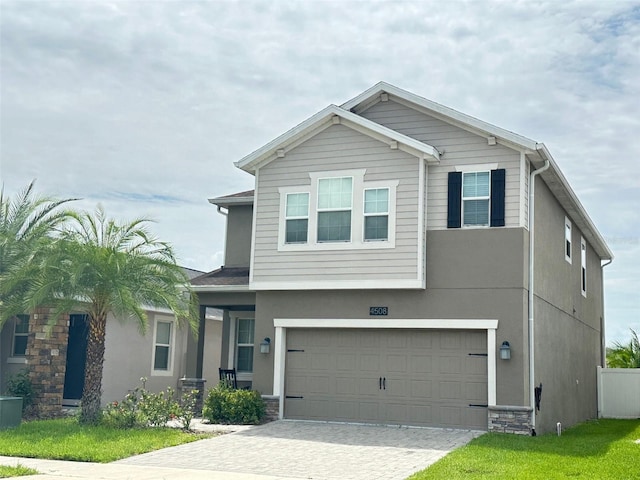 view of front of house with a garage and central AC