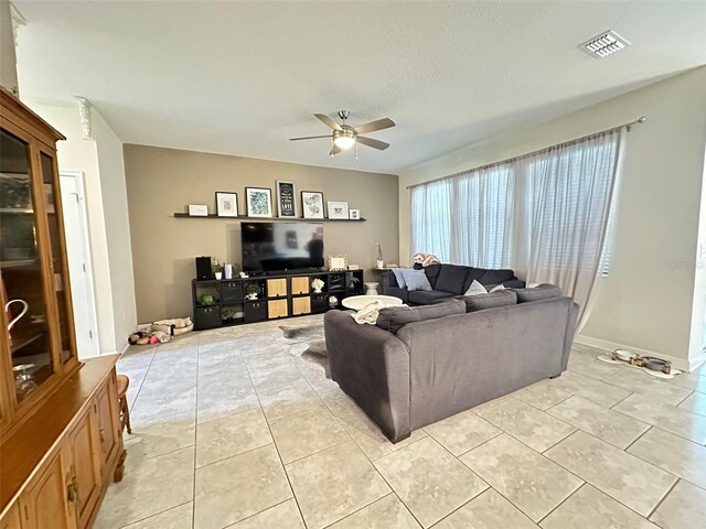 tiled living room featuring ceiling fan