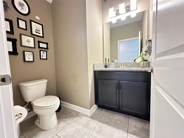 bathroom with tile patterned floors, toilet, and vanity