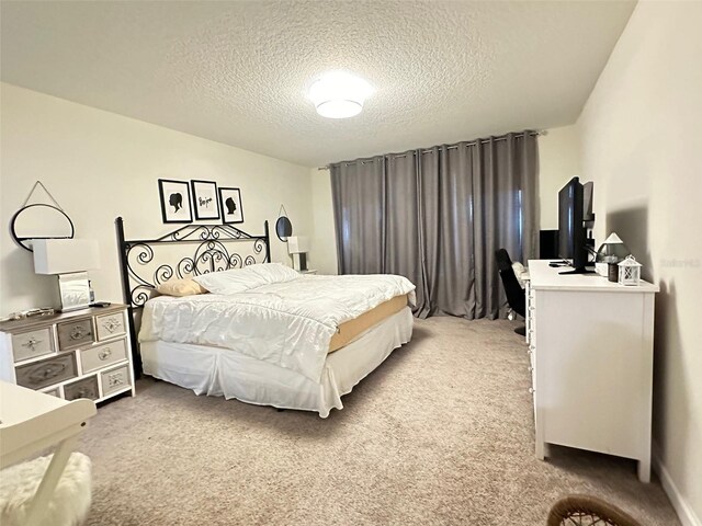 carpeted bedroom featuring a textured ceiling