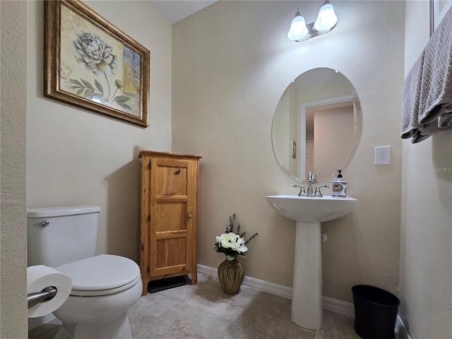 bathroom featuring tile patterned floors and toilet