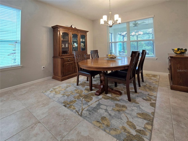 dining room featuring a notable chandelier, plenty of natural light, and light tile patterned floors