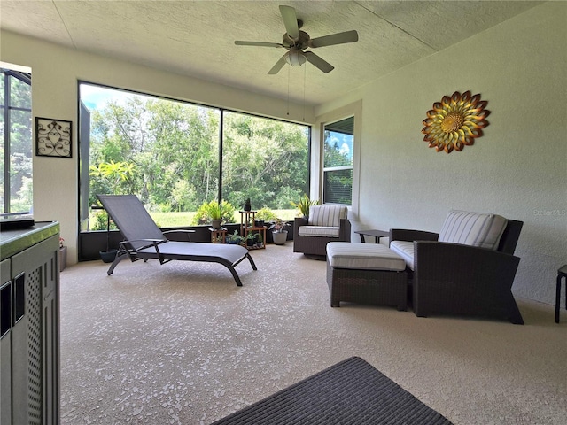 sunroom featuring a healthy amount of sunlight and ceiling fan