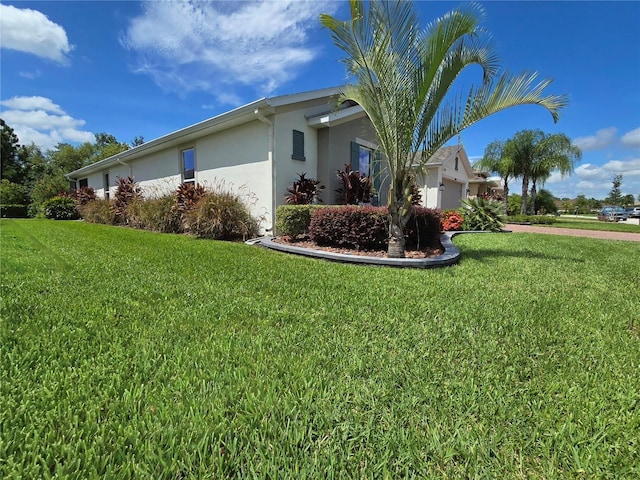 view of side of home featuring a yard